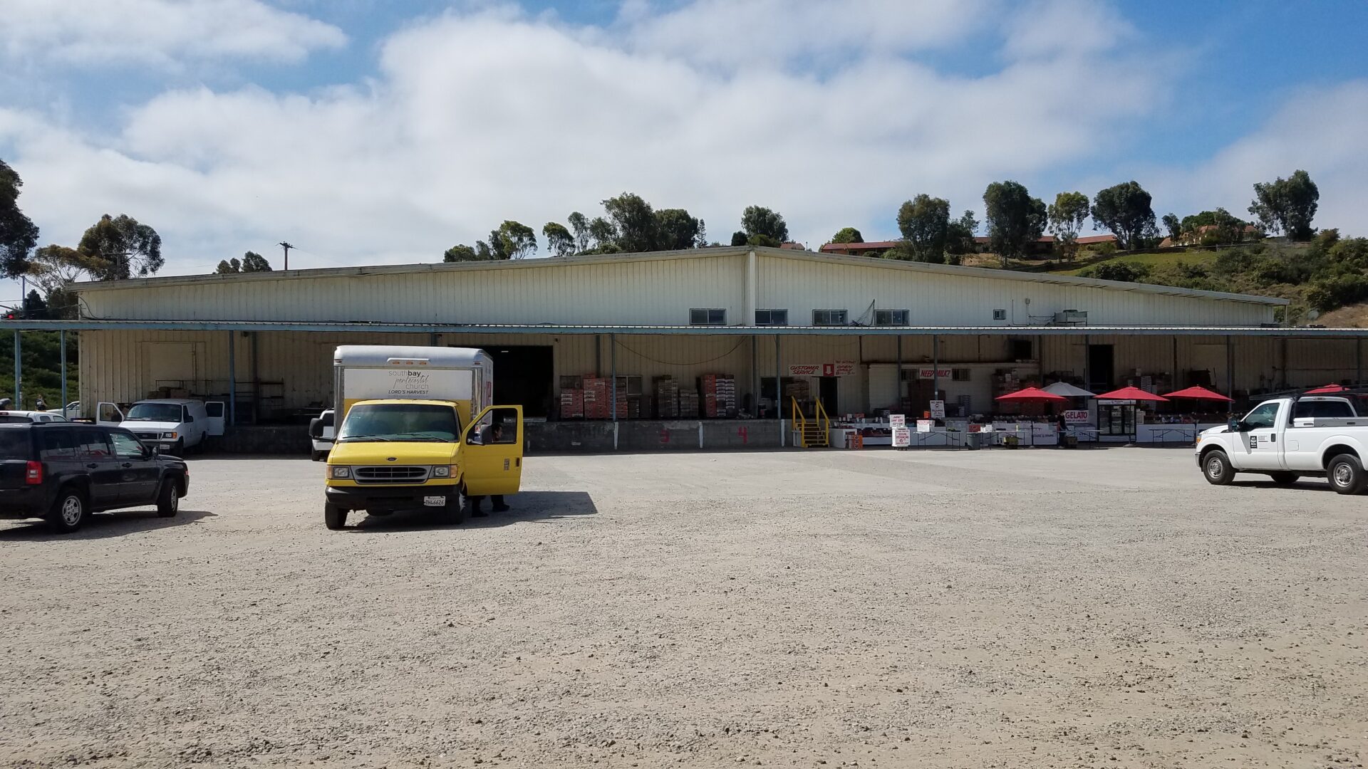 A yellow truck parked in front of a building.
