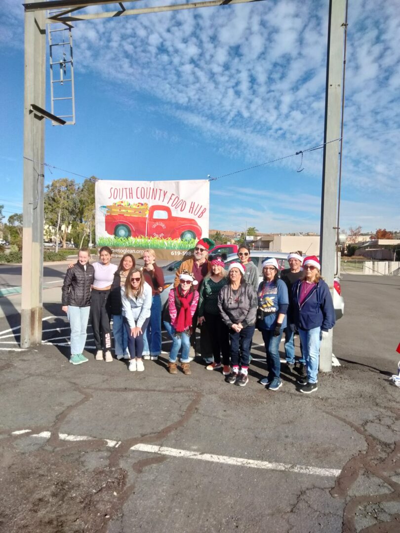 A group of people standing in front of a red truck.